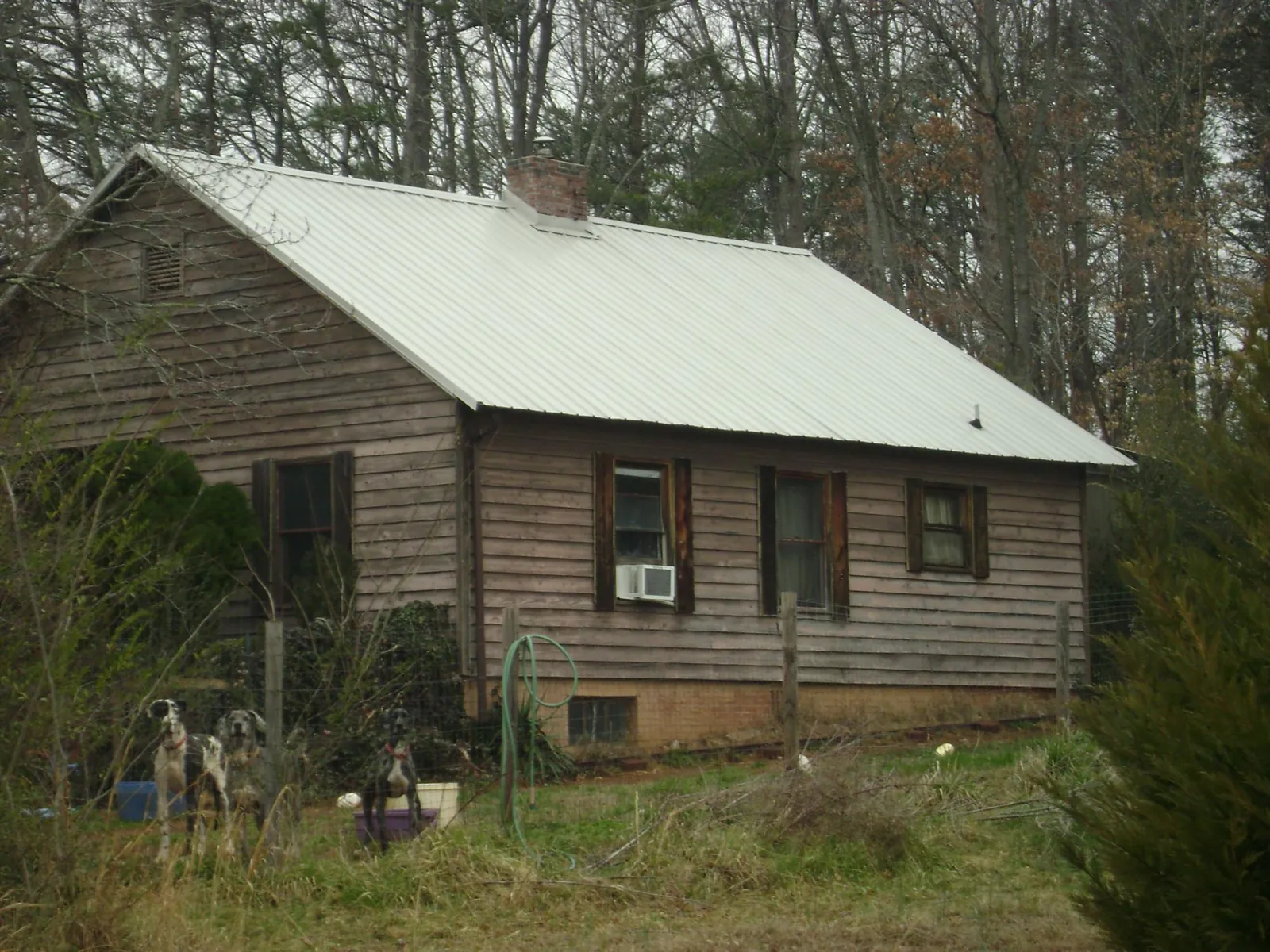 White metal roof on an old wood sided farmhouse, from a Metal Roof Installation job in Jonesburg